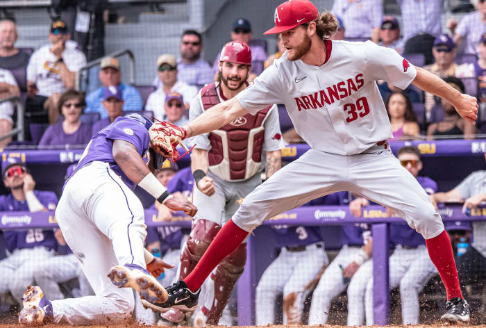 Arkansas pitcher Hunter Hollan applies the tag at the plate in a Game 1 win against LSU in Baton Rouge.